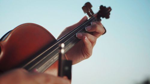 Close-up of man playing guitar