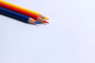 Close-up of colored pencils against white background