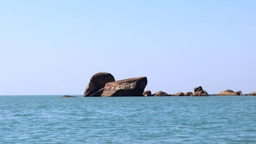 Scenic view of sea against clear blue sky