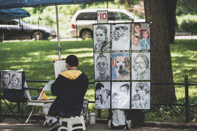 Man making sketch against at park