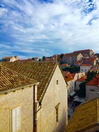 Houses against cloudy sky