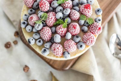 Directly above shot of frozen berries on cheesecake at table