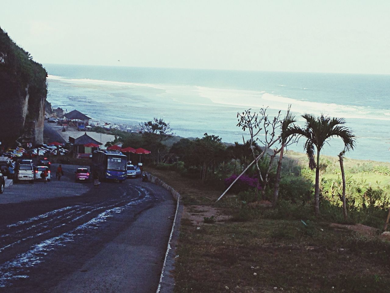 sea, horizon over water, water, beach, tree, transportation, sky, clear sky, road, tranquil scene, tranquility, palm tree, nature, shore, scenics, land vehicle, the way forward, car, beauty in nature, mode of transport