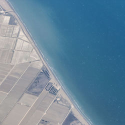 Aerial view of sea seen through airplane window