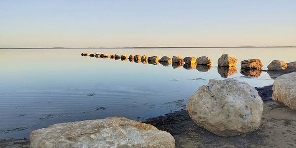 Rocks in sea against sky