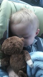 Close-up of cute boy sleeping in car