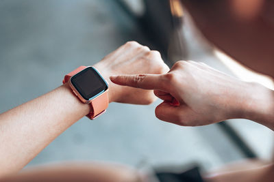 Close-up of man using smart watch