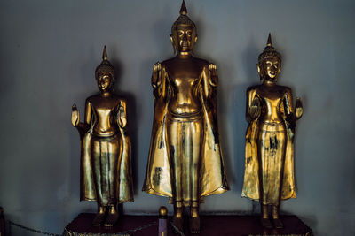 Statue of buddha against wall