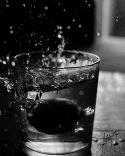 Close-up of water splashing in glass