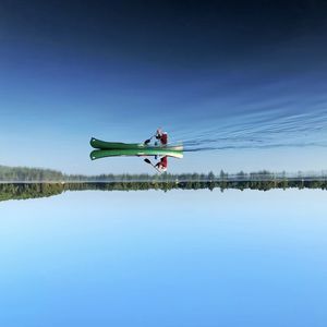 Man on lake against sky