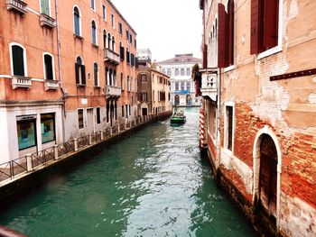 Canal amidst buildings in city