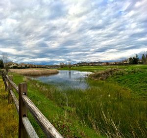 Scenic view of lake against cloudy sky