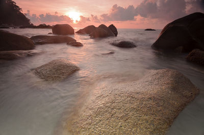 View of calm beach at sunset