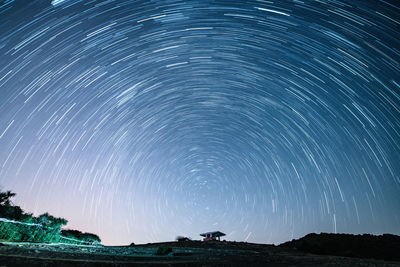 Scenic view of star trails at night