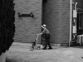 Side view of a woman walking on footpath