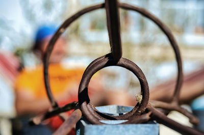 Close-up of rusty wheel against blurred background