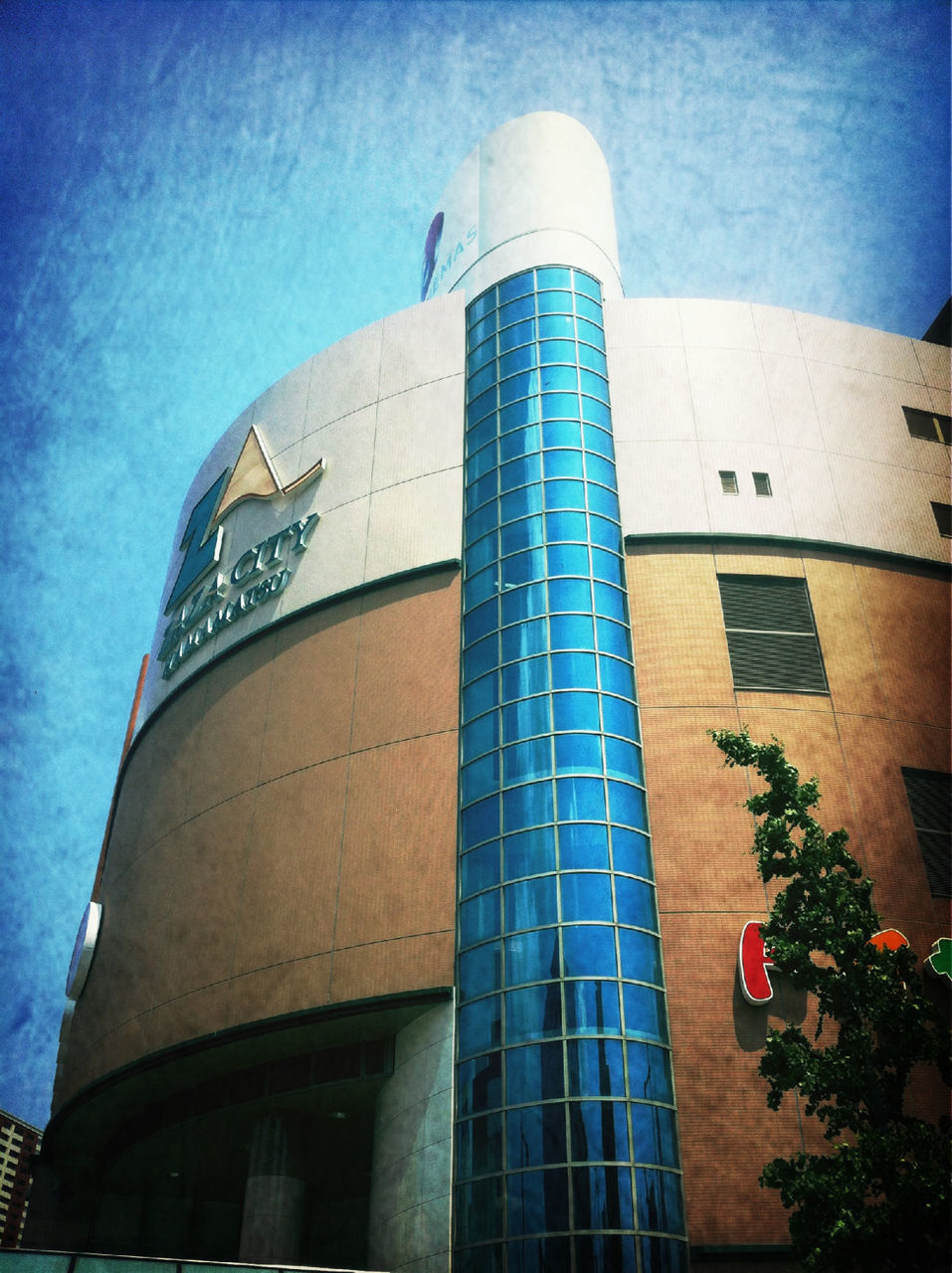 architecture, building exterior, built structure, low angle view, blue, building, window, sky, city, modern, tower, day, exterior, glass - material, no people, outdoors, facade, sunlight, tall - high, office building