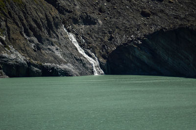 Scenic view of sea by mountain