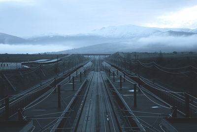 Railroad tracks against mountains