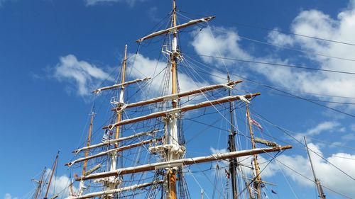 Low angle view of sailboat masts against sky