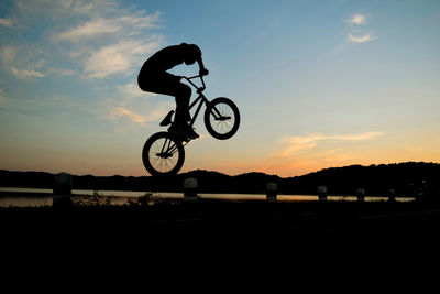 Silhouette of man on bmx bicycle