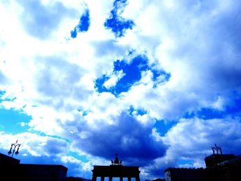 Low angle view of building against cloudy sky