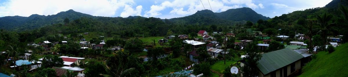 Panoramic view of trees and buildings against sky