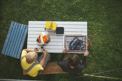 High angle view of people sitting on grass
