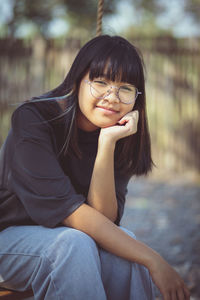 Portrait of teenage girl sitting outdoors