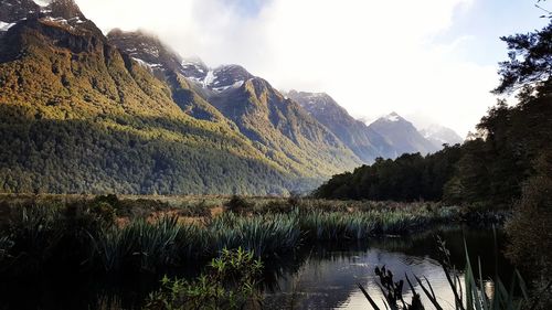 Scenic view of lake against cloudy sky