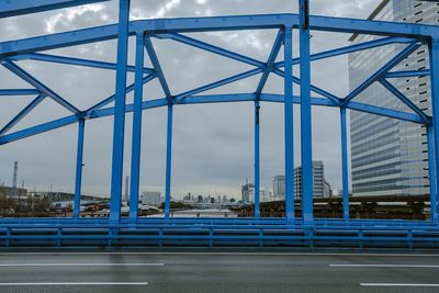 View of bridge and buildings against sky