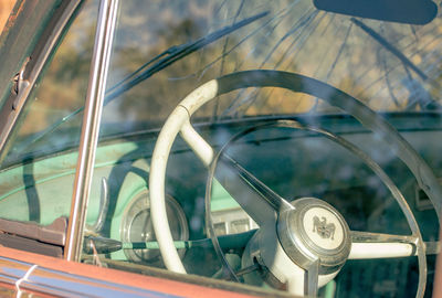 Close-up of abandoned car parked in field