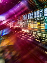 Blurred motion of illuminated bridge in city at night