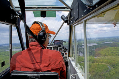 Rear view of man flying helicopter