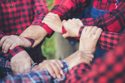 Cropped image of people forming hand chain