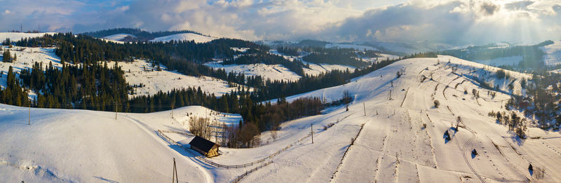 Panoramic view of snowcapped mountains against sky