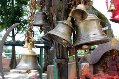 Close-up of old bell hanging outside temple