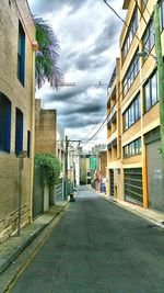 Empty road with buildings in background