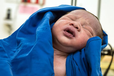 Close-up of boy with blue eyes closed