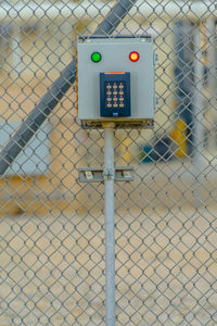 Close-up of sign on chainlink fence