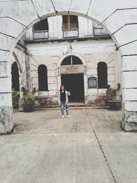 Rear view of man standing by building