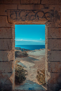 Scenic view of sea against sky seen through window
