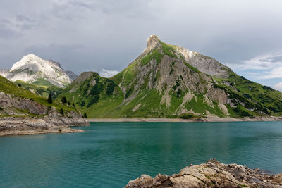 Scenic view of lake and mountains against sky