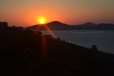 Scenic view of silhouette mountains against sky during sunset