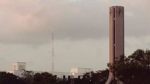 Low angle view of modern building against cloudy sky