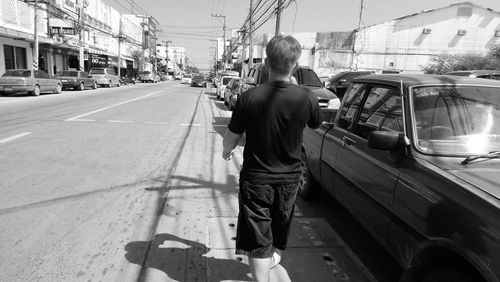 Rear view of woman on street in city