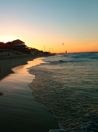 Scenic view of sea against clear sky at sunset