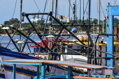 Sailboats moored in sea against sky