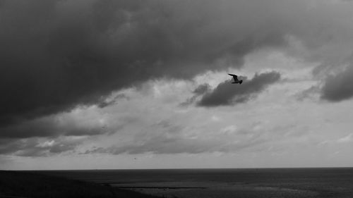 Scenic view of sea against cloudy sky