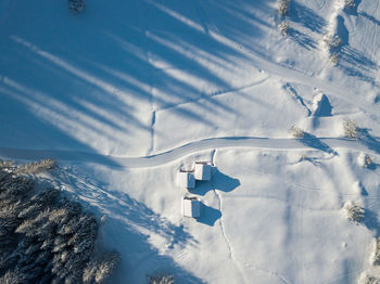 Aerial view of snow covered land and mountains